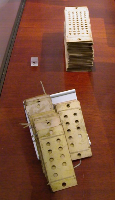 Thick, hole-punched cards strung together